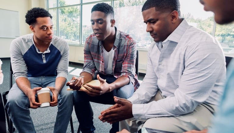 Group of men participating in an anger management discussion